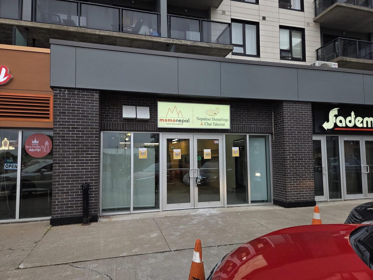 The MomoNepal takeout shop on Supreme Court, Halifax: a glass storefront under a lit sign reading Nepalese Dumplings and Chai Takeout
